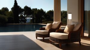 two wicker chairs sit on a patio next to a swimming pool